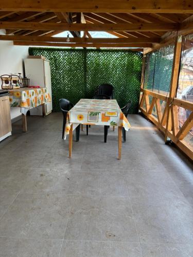 a room with a table and chairs in it at Анелия in Sapareva Banya