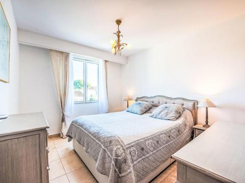 a bedroom with a bed and a window at Apartment Le Domaine de la Baie-4 by Interhome in Cavalaire-sur-Mer