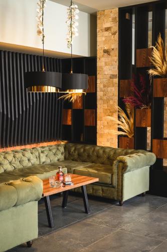 a living room with a couch and a table at Grand Hotel Velingrad in Velingrad