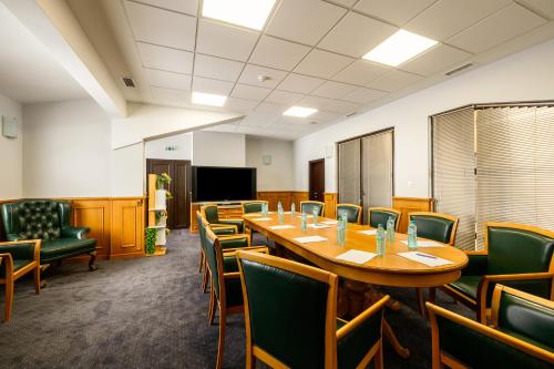 a conference room with a long table and chairs at Grand Hotel Velingrad in Velingrad