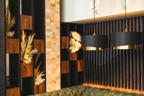a room with a couch and two chandeliers at Grand Hotel Velingrad in Velingrad