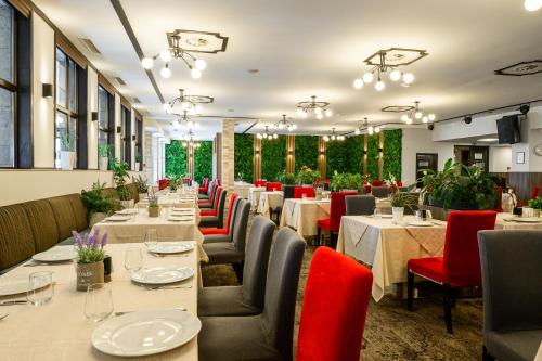 a dining room with long tables and chairs at Grand Hotel Velingrad in Velingrad