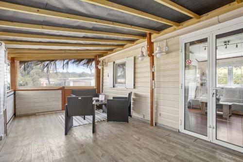a room with a table and chairs and a window at Mobilhome Puget-sur-argens in Puget-sur Argens