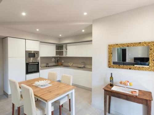 a kitchen and dining room with a wooden table and chairs at Holiday Home Maria by Interhome in Intra