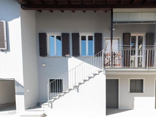 a white building with a staircase and windows at Holiday Home Maria by Interhome in Intra