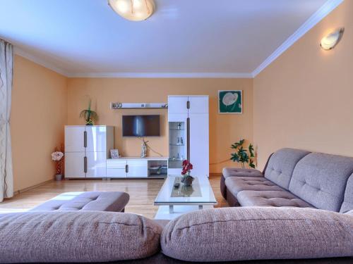 a living room with two couches and a refrigerator at Holiday Home Soriso by Interhome in Motovun
