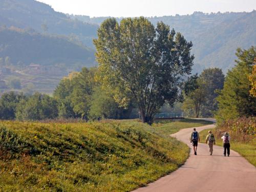 three people walking down a dirt road at Holiday Home Soriso by Interhome in Motovun
