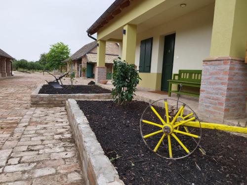 a yellow wagon in front of a house at Dvori 1882 in Karanac
