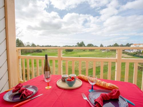 einen Tisch mit einer Flasche Wein und einem Teller Essen in der Unterkunft Apartment L'Orée du Golf-2 by Interhome in Pornic