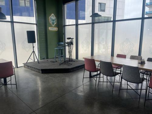 a conference room with a table and chairs and a stage at Paradise Comfort Apartments in Batumi