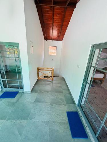 an empty room with a wooden ceiling and glass doors at LiliVilla Srilanka in Aluthgama