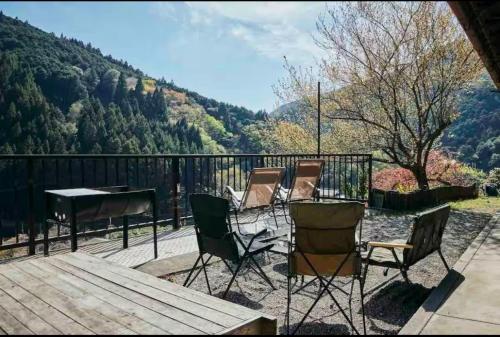 a group of chairs and a table on a deck at Rebe東吉野 in Washika