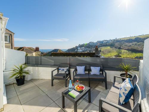 a patio with chairs and a table on a balcony at Holiday Home Lighthouse Watch by Interhome in Mevagissey