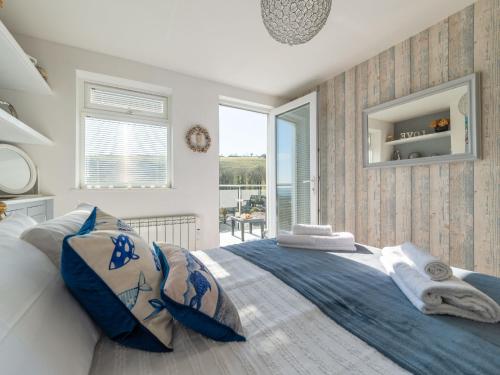 a bedroom with a large bed with towels on it at Holiday Home Chy An Mor by Interhome in Mevagissey