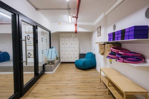 a room with a hallway with a bench and a locker room at Communit Penthhous - Urban Vacation & Port View in Haifa