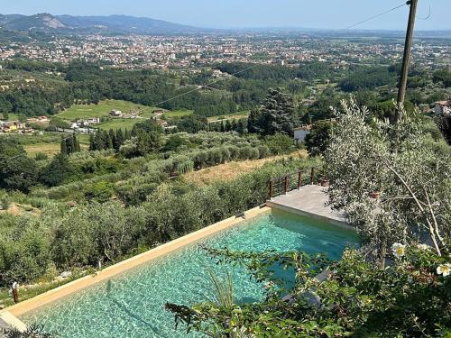 a swimming pool with a view of a city at Villa Panorama by Interhome in Colle di Buggiano