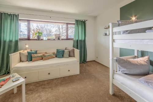 1 dormitorio con 2 literas y sofá en Fewo Strandliebe, en Gaienhofen