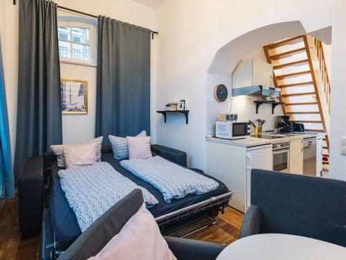 a living room with a bed and a kitchen at Altstadt-Studios Neuer Markt in Stralsund