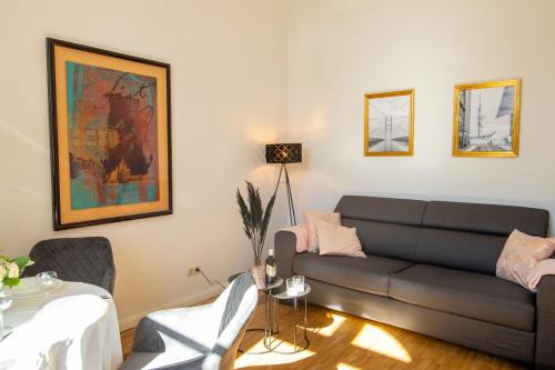 a living room with a couch and a table at Altstadt-Studios Neuer Markt in Stralsund
