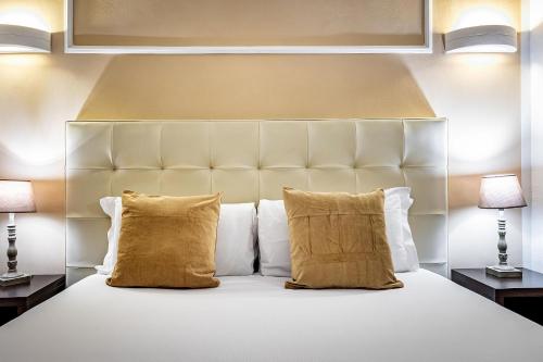 a bedroom with a white bed with two lamps at B&B De Biffi in Florence