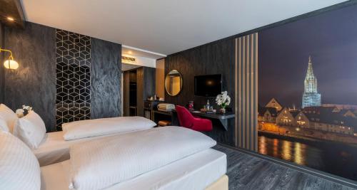 a hotel room with two beds and a view at PLAZA Premium Parkhotel Neu-Ulm in Ulm