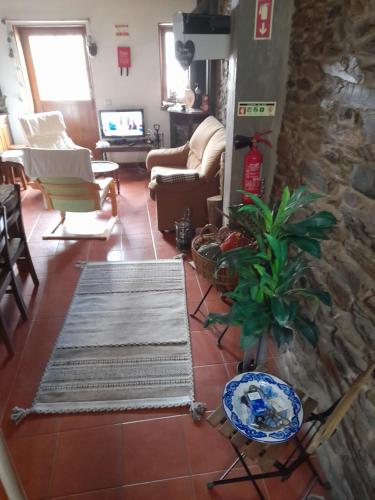 a living room with a couch and a table at Latada Suit's Serra da Estrela in Sameiro