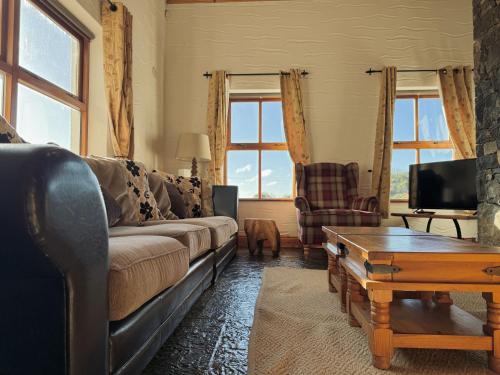 a living room with a couch and a coffee table at Stargazers Cottage in Doolin