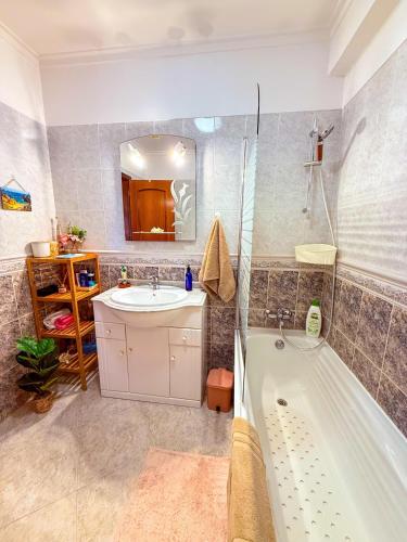 a bathroom with a tub and a sink and a shower at Superhost Stay Garden View Double Room near Lisbon and Beaches in Corroios