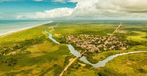 an aerial view of a town next to the beach at Pousada dos Corais in Itaúnas