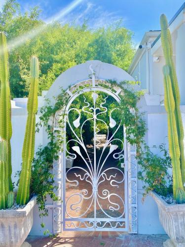 a gate to a garden with cactus at 1 Royal Street Guesthouse in Riebeek-Kasteel