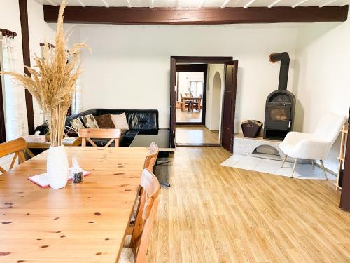 a living room with a wooden table and a fireplace at Chalupa Rozálka in Cerny Dul