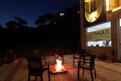 a fire pit in front of a store at night at UNIQUE RESORT INN Yercaud in Yercaud