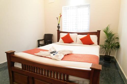 a bedroom with a bed with towels on it at UNIQUE RESORT INN Yercaud in Yercaud