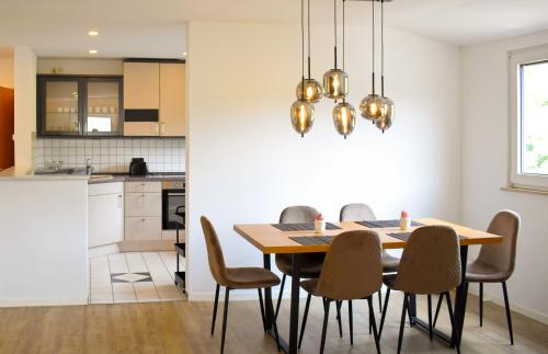 a kitchen and dining room with a table and chairs at Hotel Emmerich in Winningen