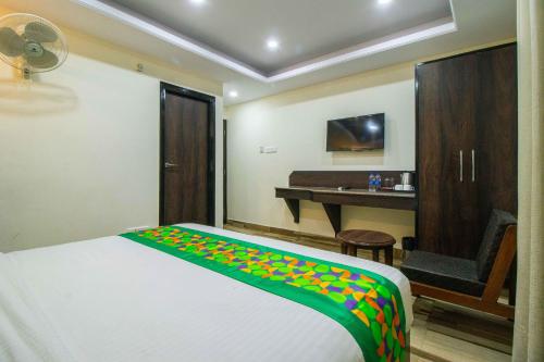 a bedroom with a bed and a desk in a room at Treebo Maharaja, Near Mall Road in Shimla
