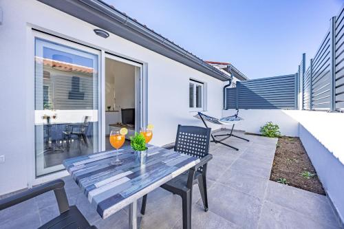 a patio with a table and chairs on a balcony at Barbariga Beach Paradise 1 in Peroj