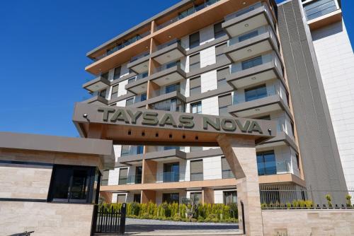 a building with a sign that reads taxias nova at Halil Aslan Taysas Nova in Gazipasa