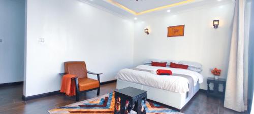 a bedroom with a bed and a chair in it at The Hills View in Nairobi