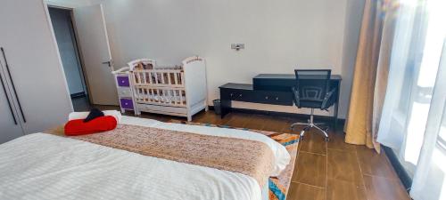 a baby room with a crib and a crib at The Hills View in Nairobi