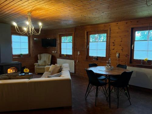a living room with a couch and a table at Blockhütte Engeln-Eifel in Kempenich