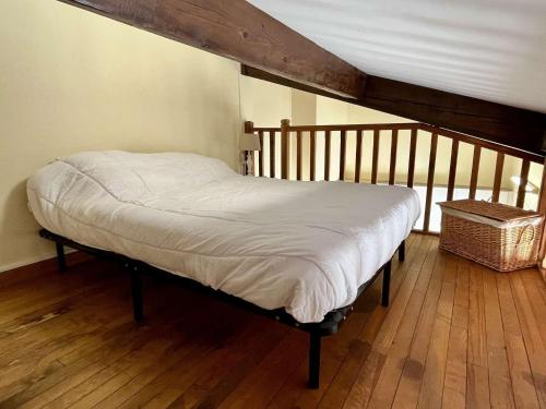 a bed in a room with a wooden floor at Appart 2 Pièces mezzanine 4 couchages ARGELES SUR MER AR090-010 in Argelès-sur-Mer
