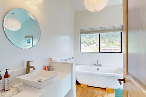 a bathroom with a white tub and a sink at Blue Mermaid in Sea Ranch