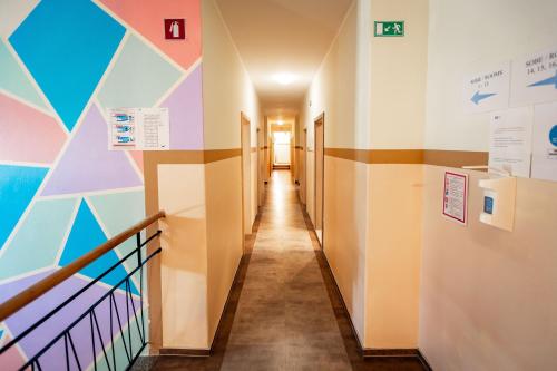 a corridor in a hospital with colorful walls and a hallway at Hostel Soline in Portorož