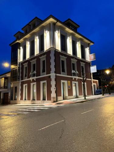 a large building on the corner of a street at Hotel Boutique Villa de Noreña in Noreña