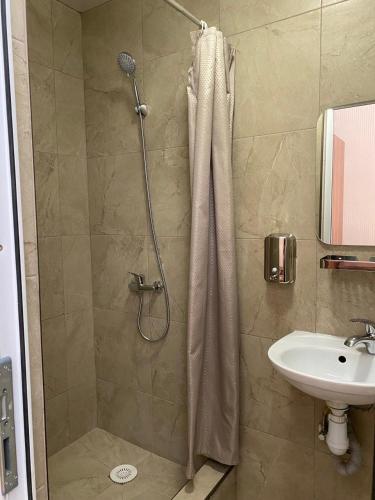 a bathroom with a shower and a sink at Відпочинковий комплекс,міні готель Старий дворик in Lviv