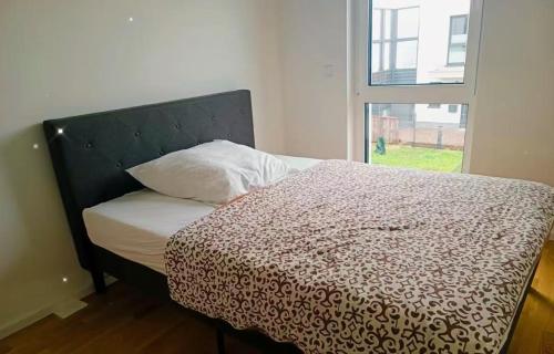 a bedroom with a bed with a pillow and a window at Messe Düsseldorf und Essen Flughafen in Ratingen