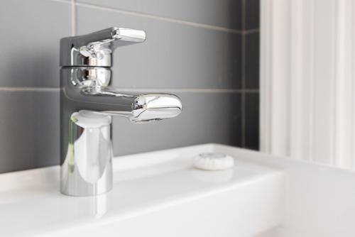 a bathroom sink with a faucet on top of it at Petrocelli apartment in La Romanina