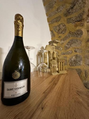 a bottle of wine sitting on a wooden table at Arc Home apartment in Agrigento