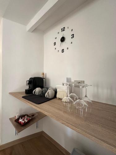 a shelf with a clock on a wall at Arc Home apartment in Agrigento