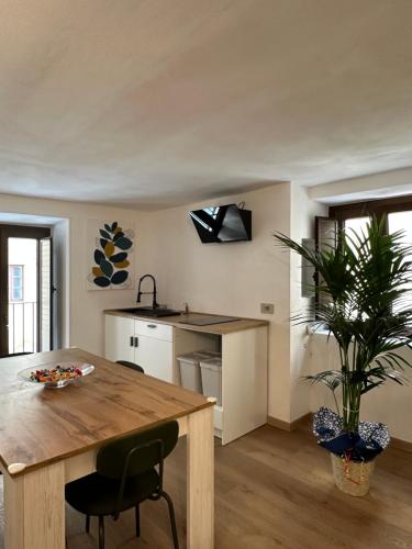 a kitchen with a wooden table and a potted plant at Arc Home apartment in Agrigento